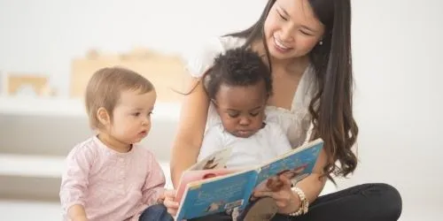 daycare teacher reading to kids